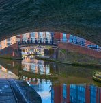 canal running under stone bridge