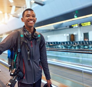 young man with luggage at airport