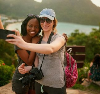 two women take a selfie in tropical location