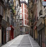 tall buildings line narrow historic street